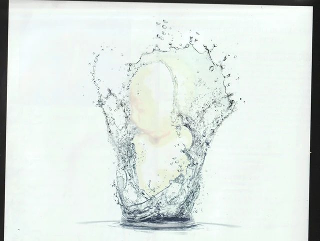 A transparent vessel formed from splashing water against a pale background.