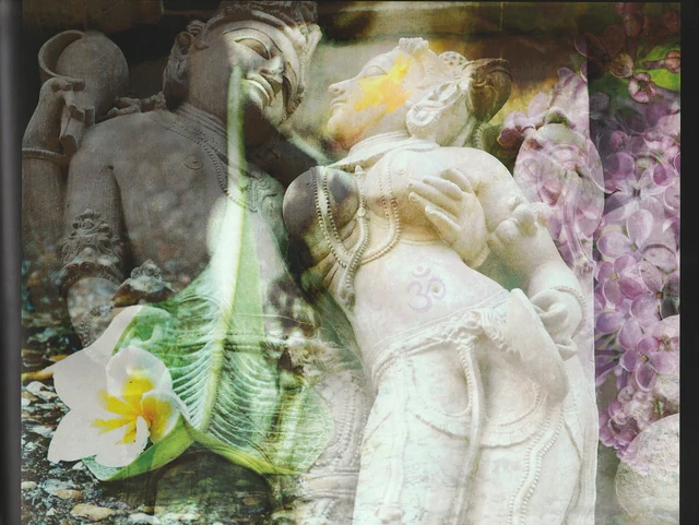 A reclining stone figure, an elephant-headed sculpture and a pale flower.